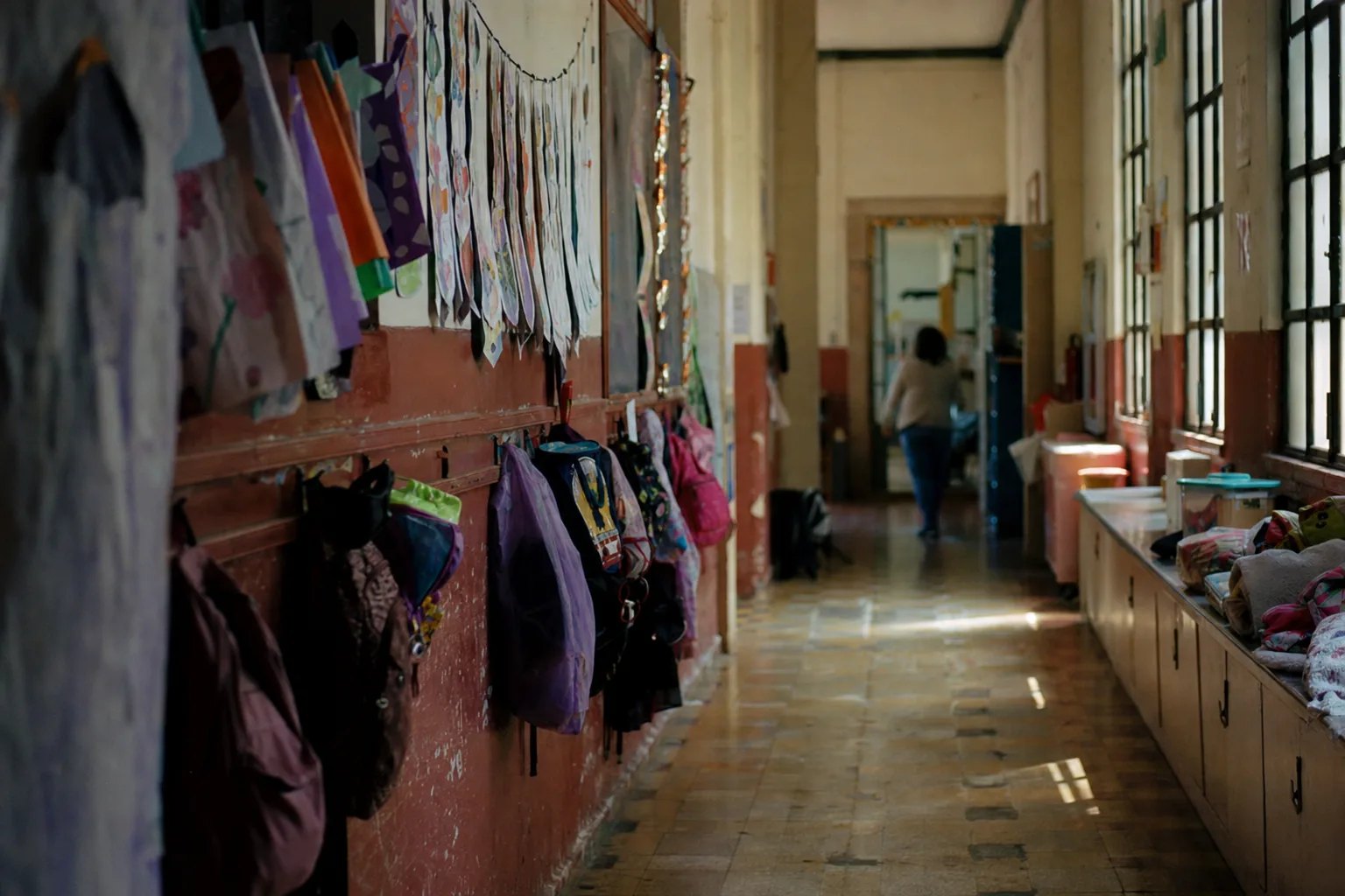 Private school corridor in the morning with backpacks and artwork on the walls